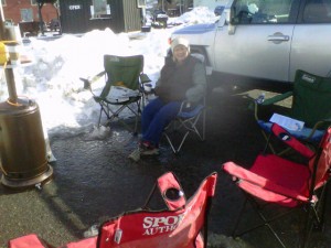 Karen's bundled up in layers trying to keep warm as we wait for people to stop for Free Prayer at Sundance Festival.